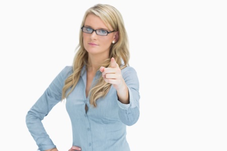 Woman looking strictly at camera while pointingの写真素材