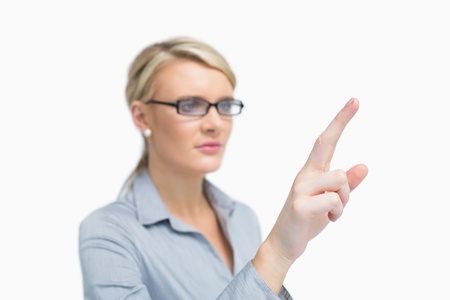 Businesswoman wearing glasses standing and pointingの写真素材