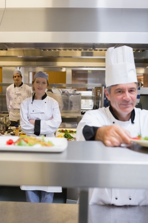 Restaurant kitchen with Chef's standing at different stationsの写真素材