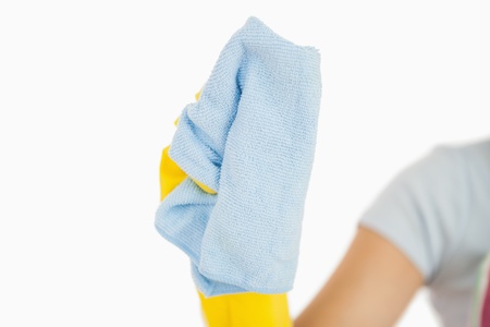 Woman in rubber gloves using blue rag