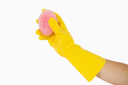 Female hand holding pink sponge in rubber gloves