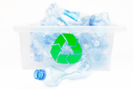 Plastic bottle in front of the box for recycling on white background