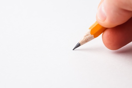Close-up of man writing with pencilの写真素材
