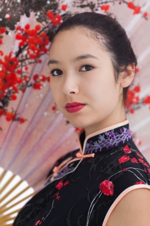 Woman wearing traditional silk kimono with fanの写真素材