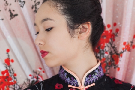 Beautiful woman wearing traditional Asian clothing with a fanの写真素材