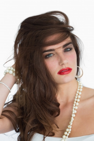 Glamorous brunette dishevelling her hairの写真素材