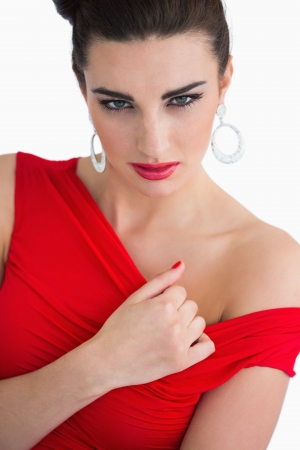 Glamorous woman touching her red dressの写真素材