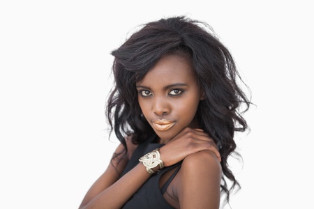 Woman posing in black dress and gold lipsの写真素材