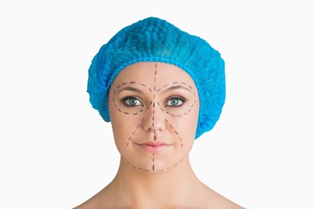 Woman with hair net and black dashes lines for a face lift in the white backgroundの写真素材