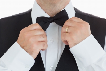 close-up of a man adjusting his bow tieの写真素材
