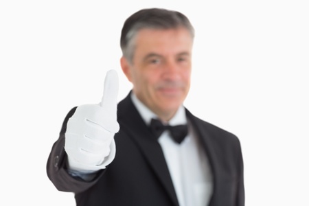 Pleased waiter having thumbs up in front of cameraの写真素材