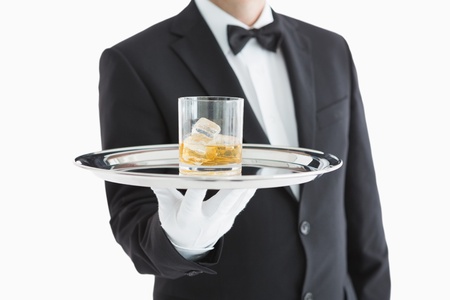 Man serving whiskey on a silver tray