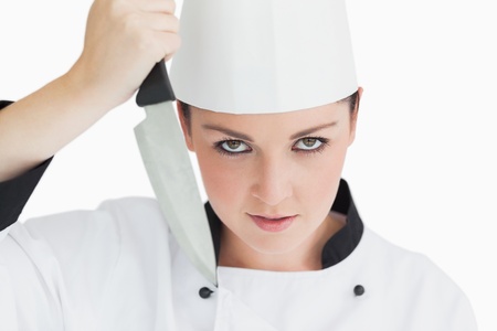 Crazy chef holding sharp knife on white backgroundの写真素材