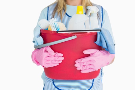 Cleaning woman holding a bucket of cleaning supplies in the white background