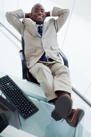 Portrait of a smiling businessman relaxing in his officeの写真素材