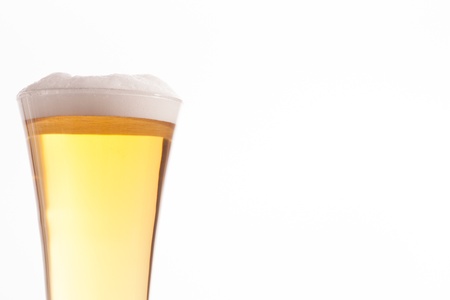 Half glass full of glass and foam against a white backgroundの写真素材