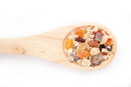 Wooden spoon with muesli  against a white backgroundの写真素材