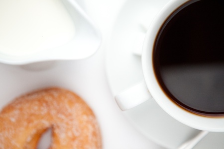 Espresso with doughnut against a white backgroundの写真素材