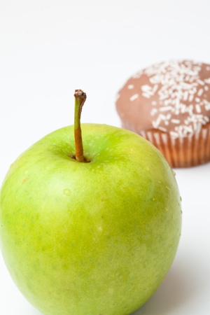 Muffin and apple against a white backgroundの写真素材
