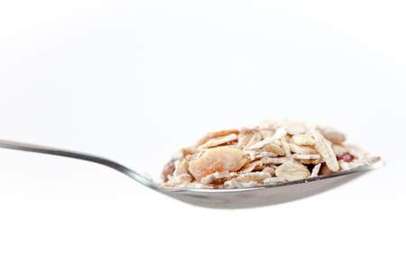 Spoon with muesli on a white backgroundの写真素材