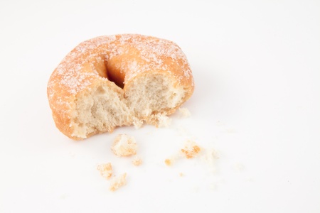 Doughnut with crumbs against white backgroundの写真素材