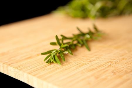Thyme on a wooden table against a black backgroundの写真素材