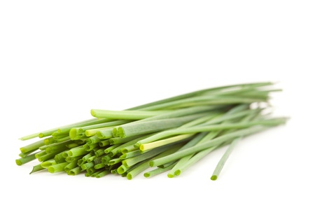 Close up of chive branches against a white background