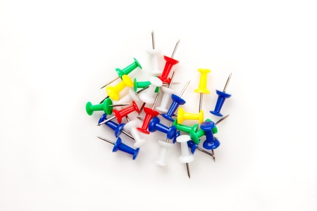 Large group of muti coloured pushpins against a white backgroundの写真素材