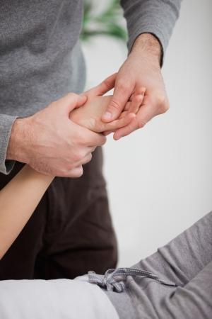 Physiotherapist massaging the hand of a patientの写真素材