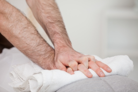Close-up of a masseur massing a woman indoorsの写真素材