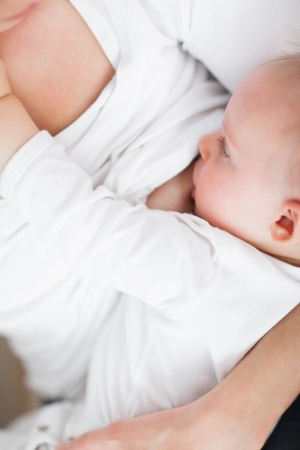Close-up of a mother breastfeeding her cute babyの写真素材