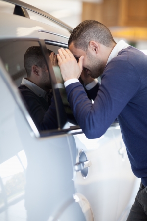 Customer looking inside a car in a garageの写真素材