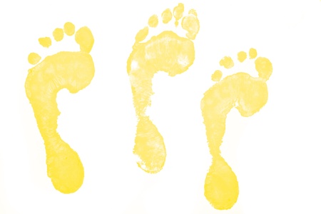 Three yellow footprints against a white backgroundの写真素材