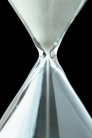 Close up of a hourglass against a black backgroundの写真素材