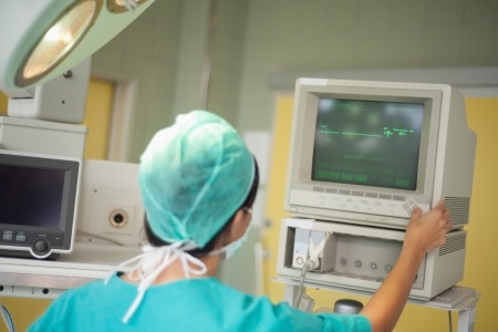 Surgeon checking a monitor in a surgical room