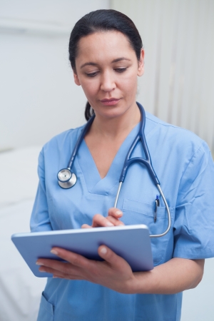 Nurse touching a tablet computer in hospital wardの写真素材