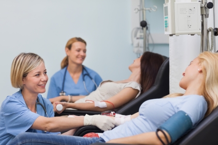 Nurse looking after a patient in hospital wardの写真素材
