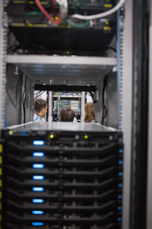 People looking after the servers in a server room in data centerの写真素材