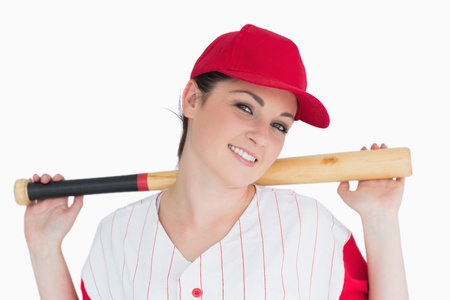 Woman holding a baseball bat on her shoulders against white background