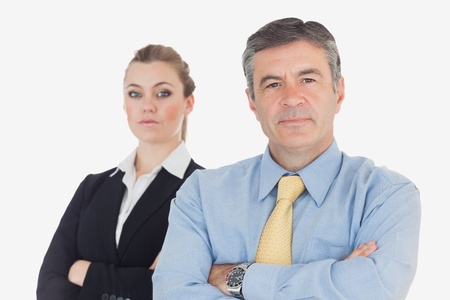 Portrait of confident business people with arms crosssed against white backgroundの写真素材