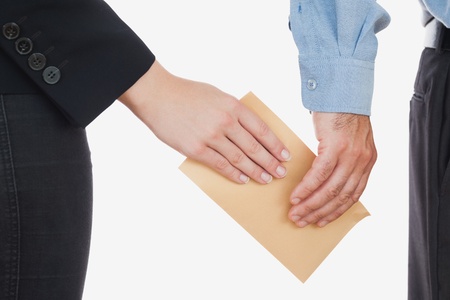Close-up of business people holding an envelope over white backgroundの写真素材