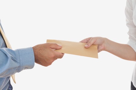 Close-up of business people holding envelope over white backgroundの写真素材