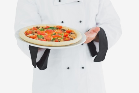Chef offering pizza over white backgroundの写真素材