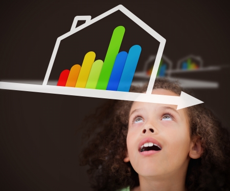 Surprised girl looking up on the picture with energy efficient house graphicの写真素材