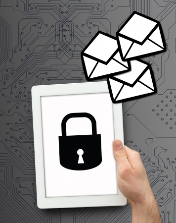 Hand holding tablet pc with lock graphic on grey computing backgroundの写真素材