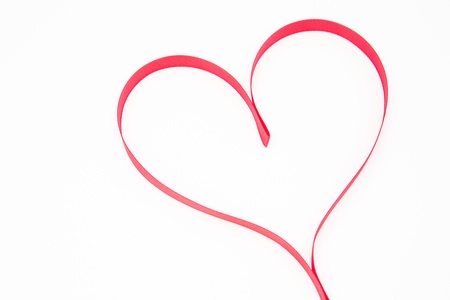 Pink heart shaped ribbon on white backgroundの写真素材