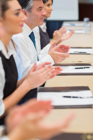 Business people clapping in a meetingの写真素材
