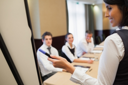 Businesswoman giving a presentation in conference roomの写真素材