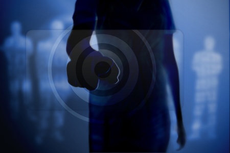 Silhouette of woman touching button on blue digital backgroundの写真素材