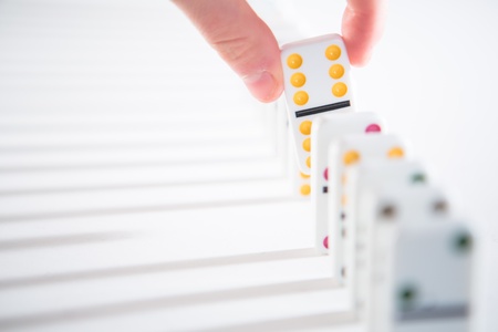 Hand taking out yellow from line on white surfaceの写真素材